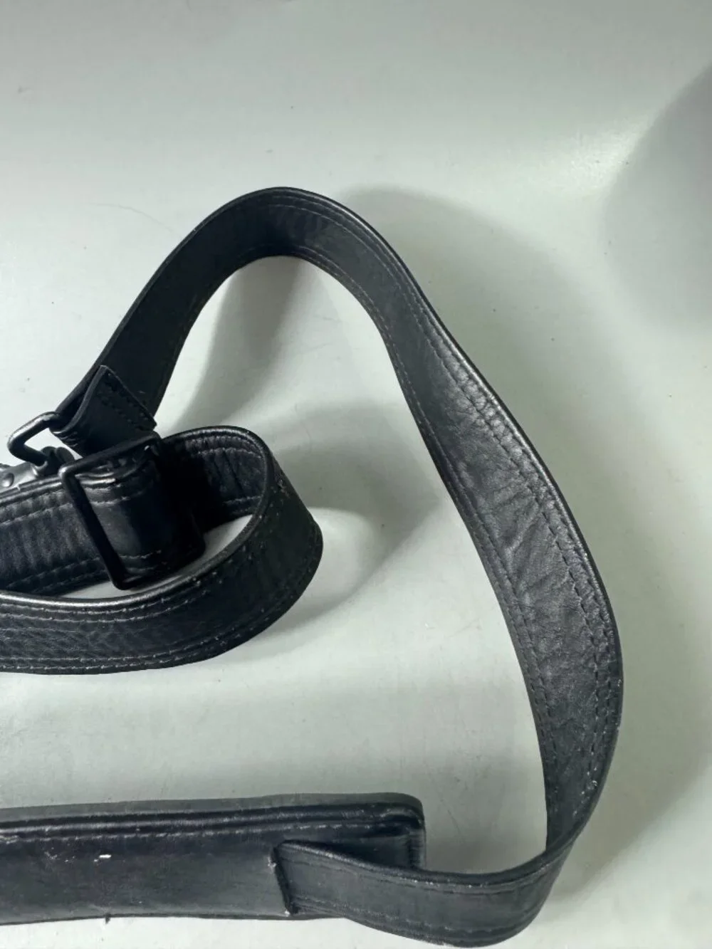 A Bundle of Two (2) Vintage Tumi Black Leather Strap and Travel Tag